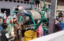 People filling water from tanker in summer