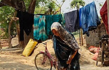 Chameli Devi drying spices in the sun