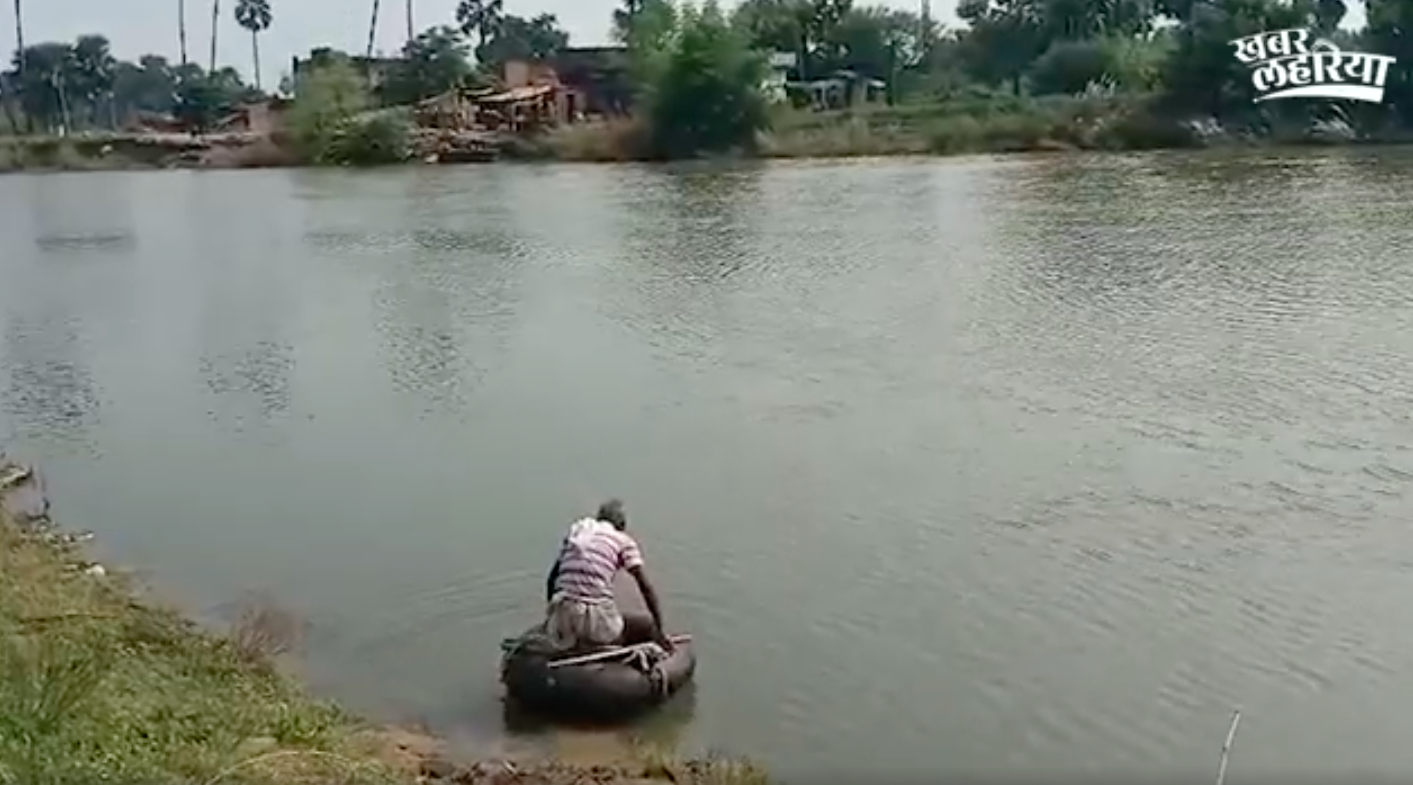 People crossing the river in a tube