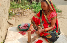 Women making bracelets from beads