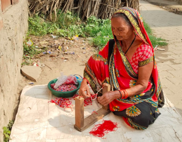 Women making bracelets from beads